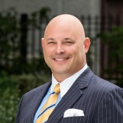 BALD WHITE MAN IN BLAZER AND YELLOW TIE