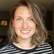 White women smiling in black and white stripe shirt