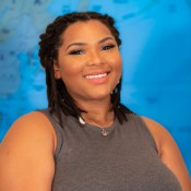 Black women smiling in grey shirt