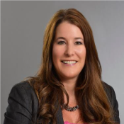 white woman in pink blouse and black blazer