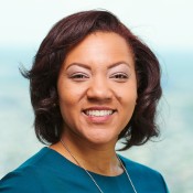 Black women smiling in blue blouse