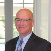 white man in blue shirt and tie