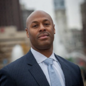 Black man in blue tie and blue blazer