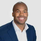 black man smiling in blue blazer and white button down shirt