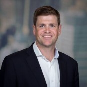 white man smiling in black blazer