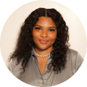 Black woman smiling in a professional headshot photo.