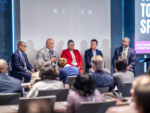 4 seated speakers on panel during PAGE 2023 R+C summit