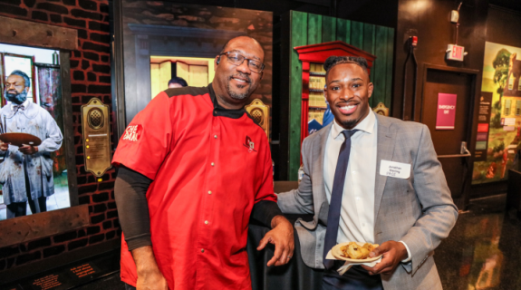 Two Black men standing together at a networking event