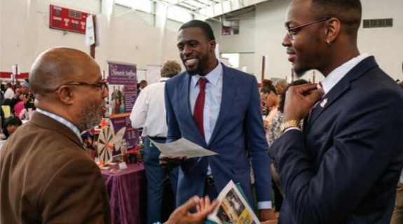 3 Black people talking together at an event