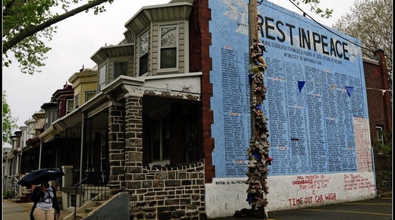 A Rest in Peace mural on the side of a row of Philadelphia houses