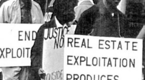 people holding signs about exploitation in a protest