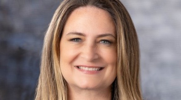 woman smiling in blue shirt and black blazer