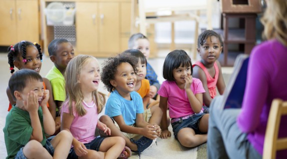 A group of small children being read to