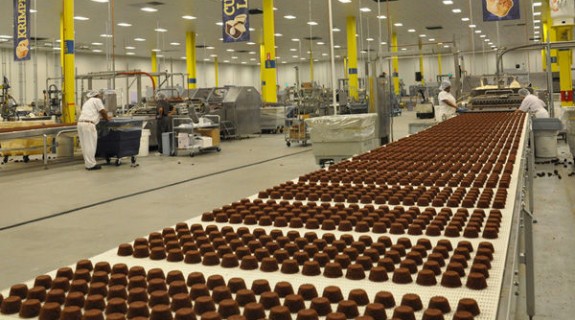 Chocolate cupcakes on an assembly line at a factory