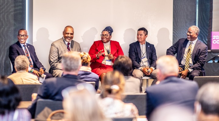 5 speakers seated smiling at page r+c summit